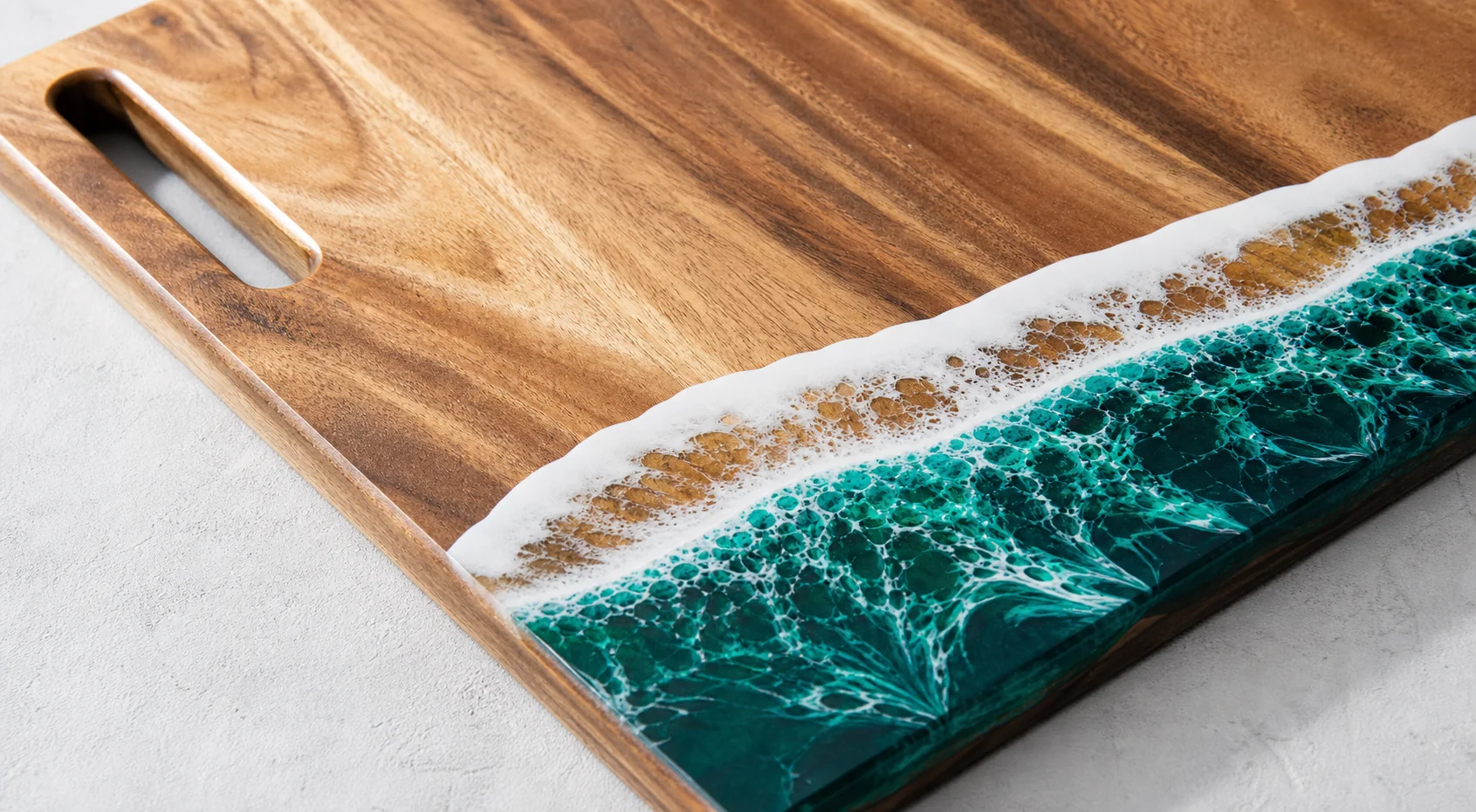 Close view of natural wood grain and a green resin wave edge on a GOGOJSM board